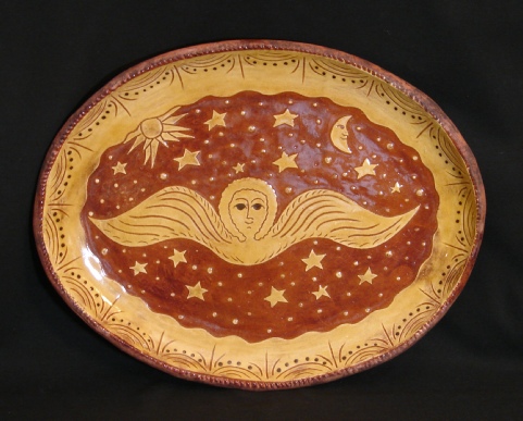 oval redware platter, angel with moon and sun