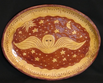 redware oval platter, angel with sun, moon and stars