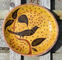 redware plate, black bird and leaves