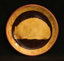 redware plate, sleeping cat