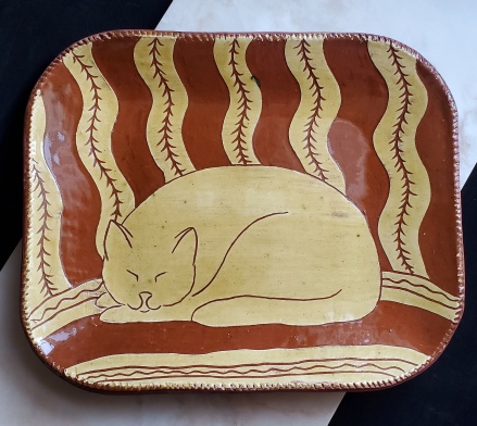 redware platter, sleeping cat