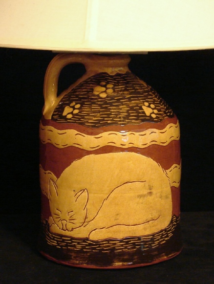 redware lamp, sleeping cat