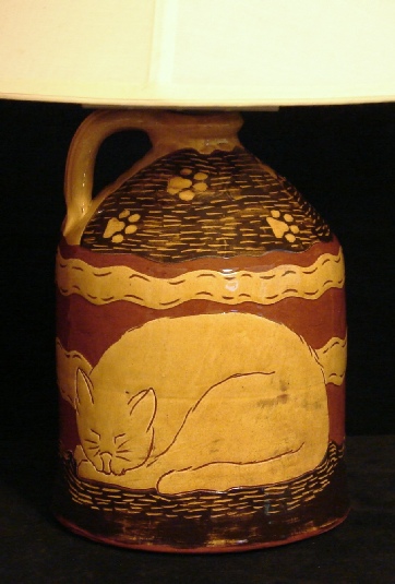redware lamp, sleeping cat