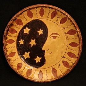 redware plate, man in the moon
