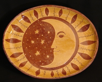 redware oval platter, man in the moon